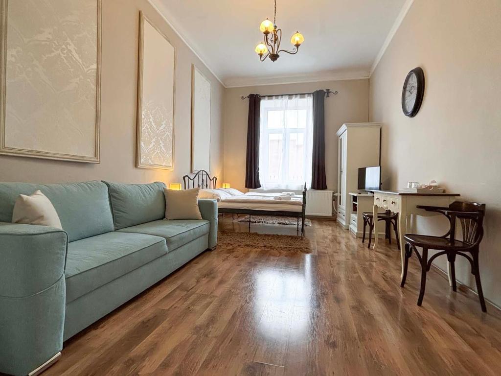a living room with a green couch and a table at Antonio Old Town Residence in Prešov