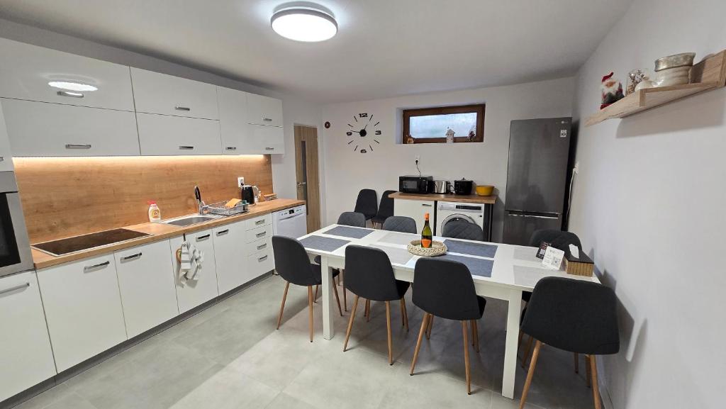 a kitchen with a table and chairs in a room at Dom Hlohovec Center in Hlohovec