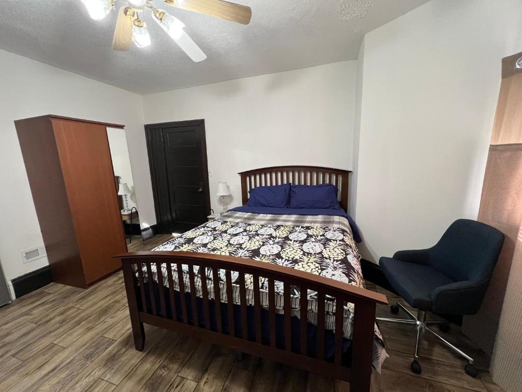 a bedroom with a bed and a blue chair at Malden Studio near Boston -- Private Stay with Kitchenette, Laundry in Malden
