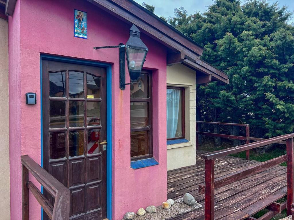a pink house with a door and a porch at Casa Pier Giorgio in El Chalten