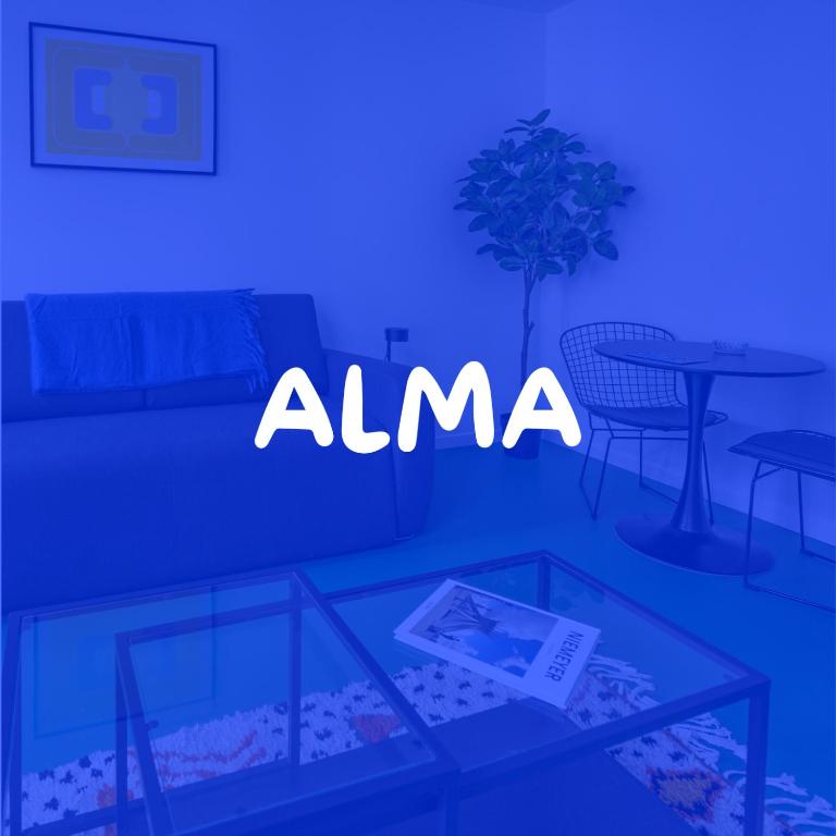 a blue room with a table and a table and a chair at Studio - Alma in Le Havre