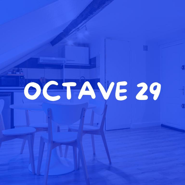 a sign that says octave in a room with chairs at Appartement - Octave 29 in Le Havre