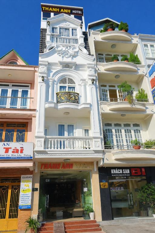 a tall white building with a clock on it at Thanh Anh Hotel Da Lat in Da Lat