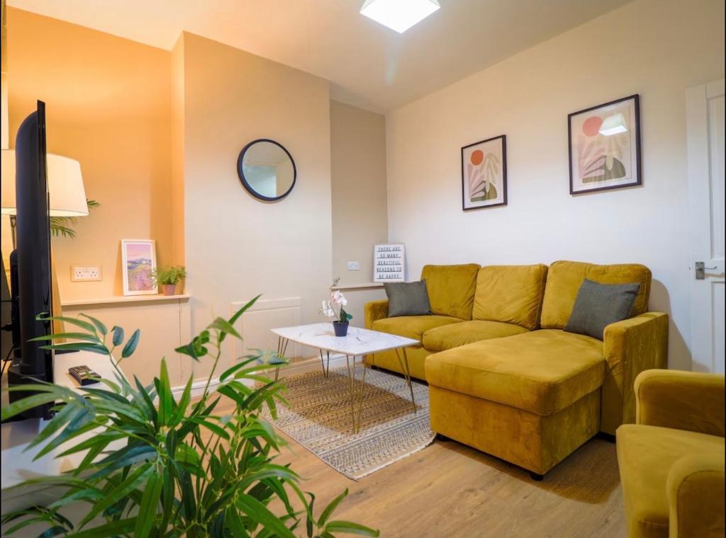 a living room with a couch and a table at London 4 Bed Contractor Base with Pool Table in Edmonton