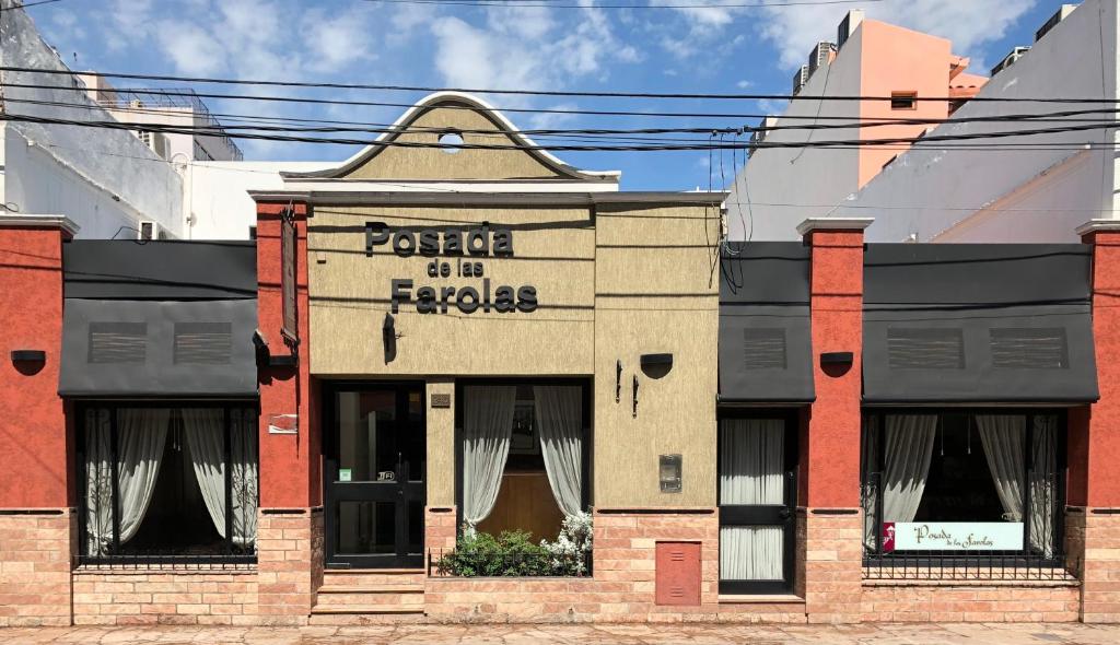 an old brick building with a sign on it at Posada de Las Farolas in Salta
