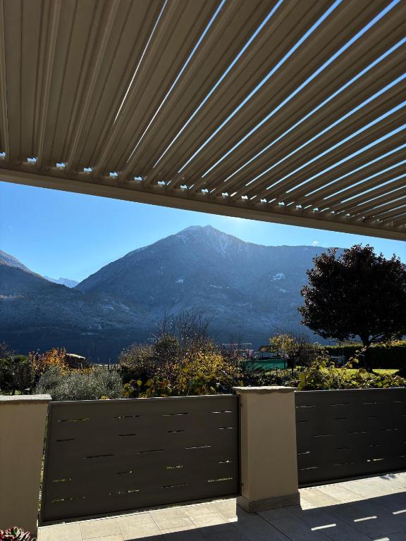 a view of a mountain range from behind a fence at La Piazzetta in Sondrio
