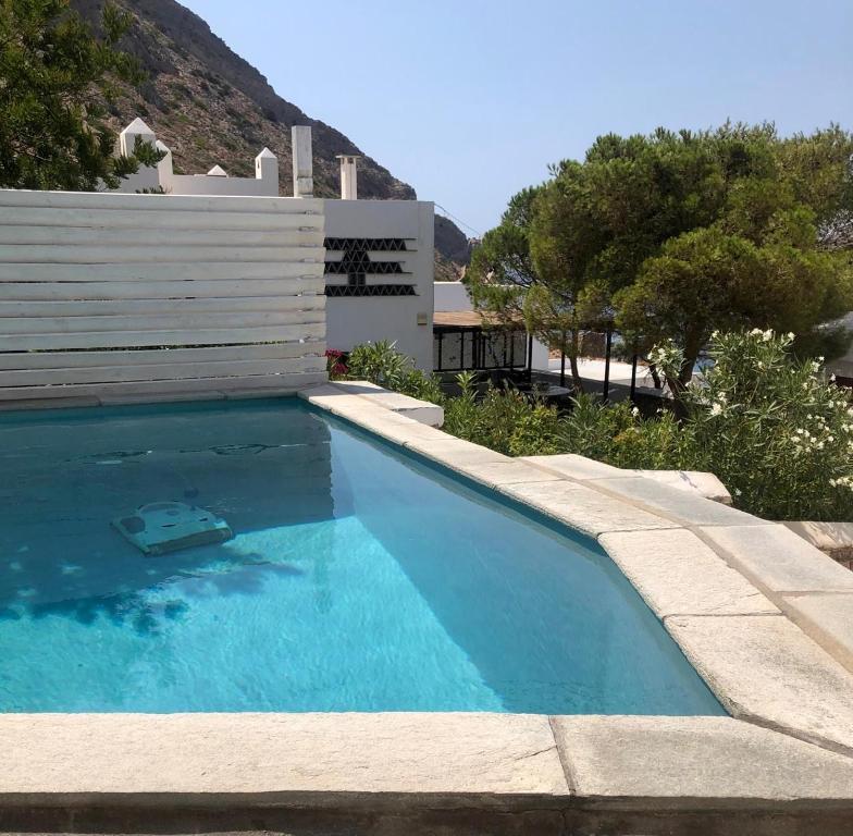 a swimming pool next to a house at Villa in Kamares, Sifnos in Kamares