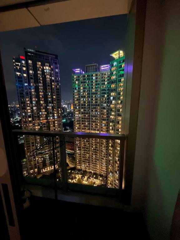a view of a city skyline at night from a balcony at 2br Luxury apartment in Jakarta