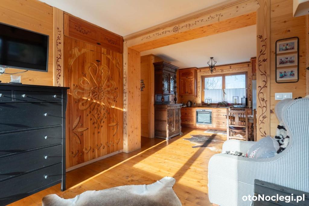 a living room with wood paneling and a tv at Willa Misiek in Zakopane