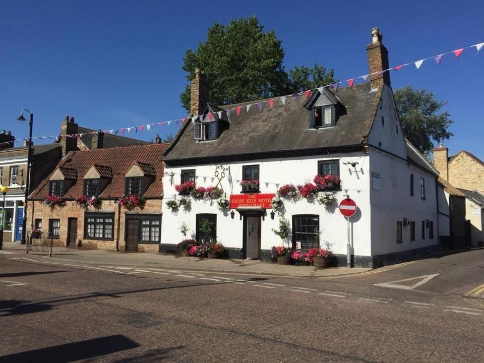 a white building on the corner of a street at Cross Keys Hotel Chatteris in Chatteris