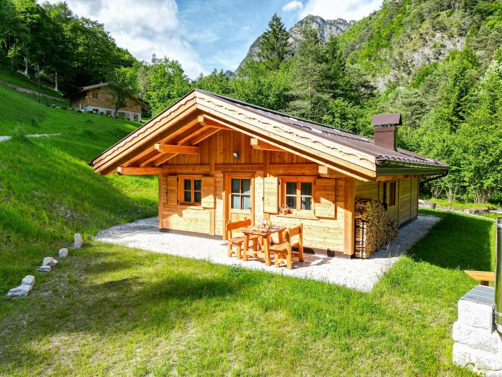 a log cabin with a picnic table in front of it at Baita Valon La Piciola in Stenico