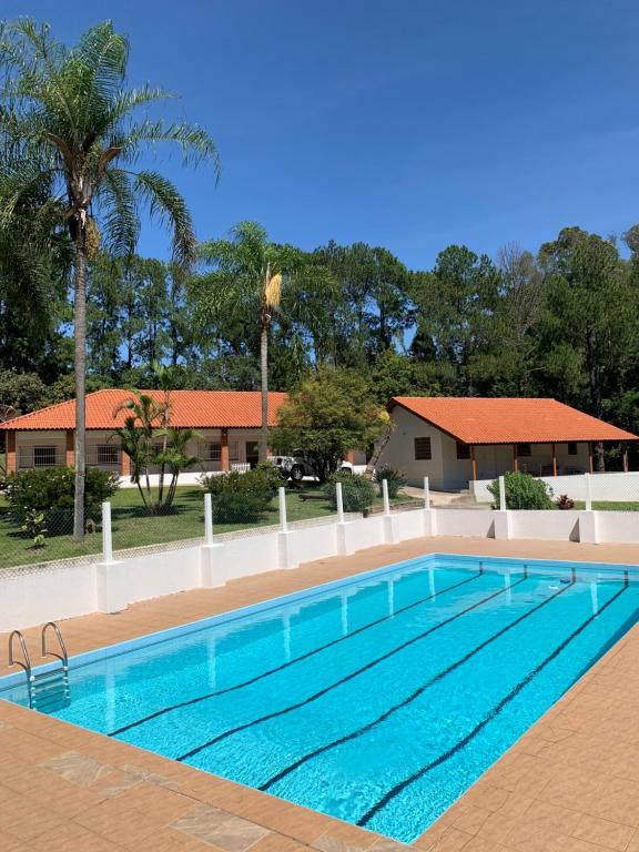 a swimming pool in front of a resort at Chácara Santa Maria in Itupeva