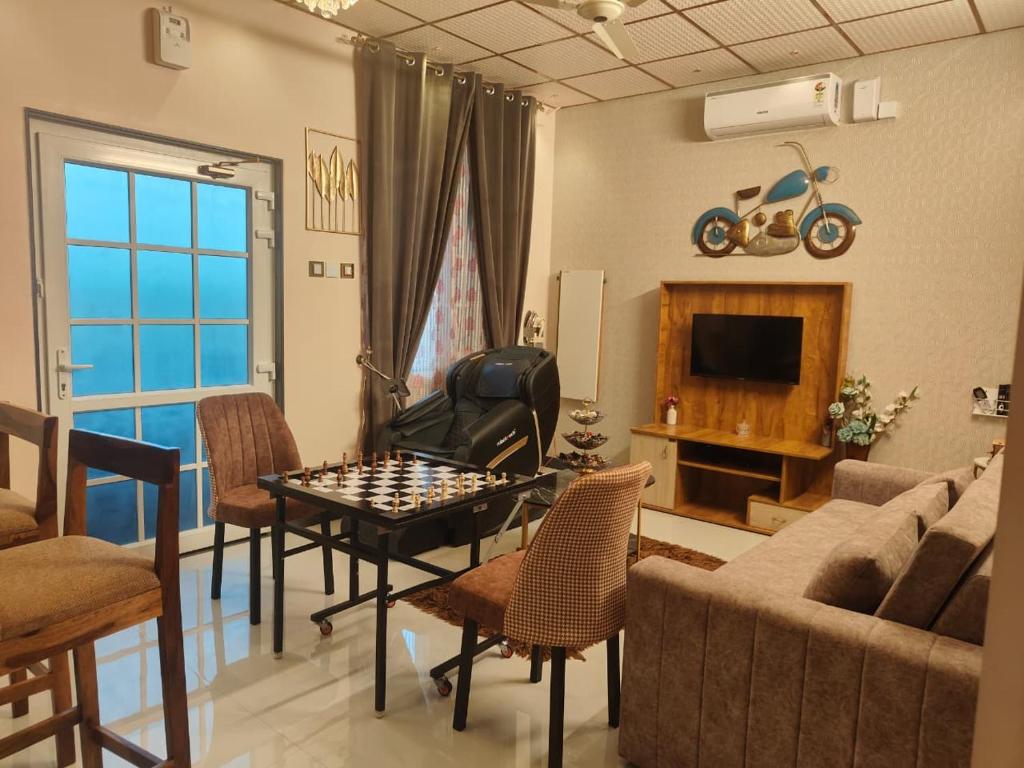 a living room with a chess board on a table at UDUPI HOMESTAY CHALET LA BONNE Vie in Udupi