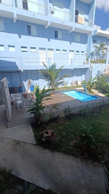 a large building with a swimming pool in front of it at Studio Home Residence in Jacareí