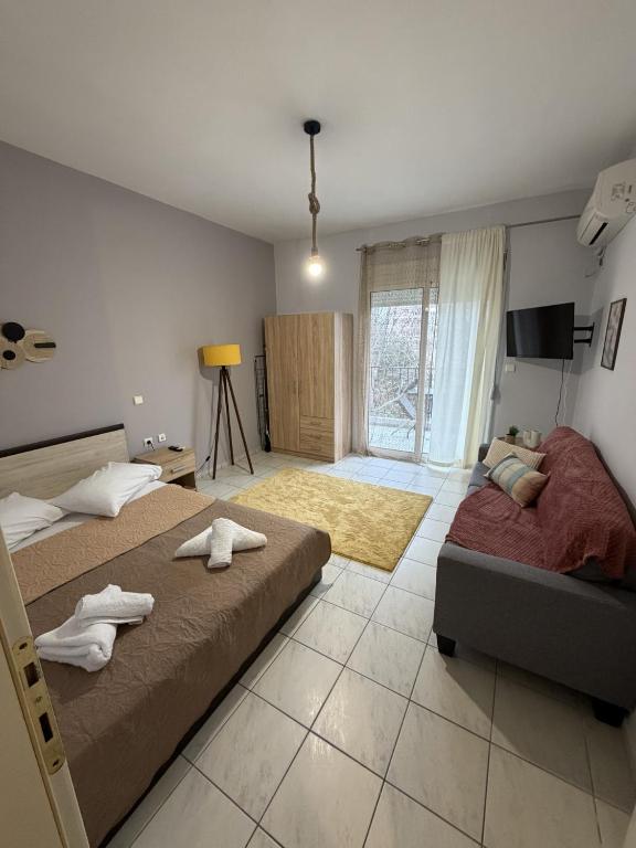 a bedroom with two beds and a television in it at Dimi's home in Komotini