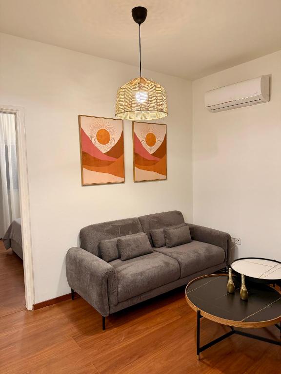 a living room with a couch and a table at Relax Beach Apartment in Larnaca