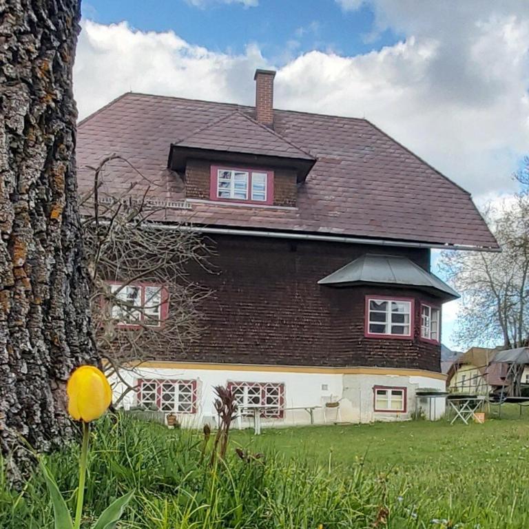 a large house with a tree in front of it at The Garden Residence in Falkenburg