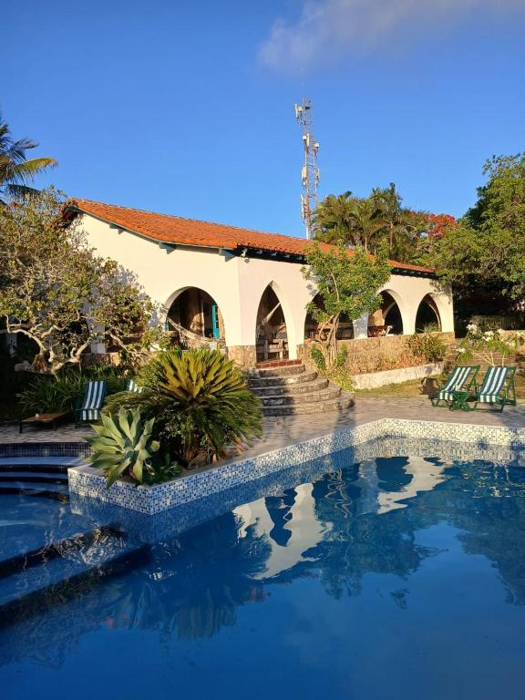 a resort with a swimming pool and a building at Casa Dos Arcos Bed and Breakfast in Arraial do Cabo