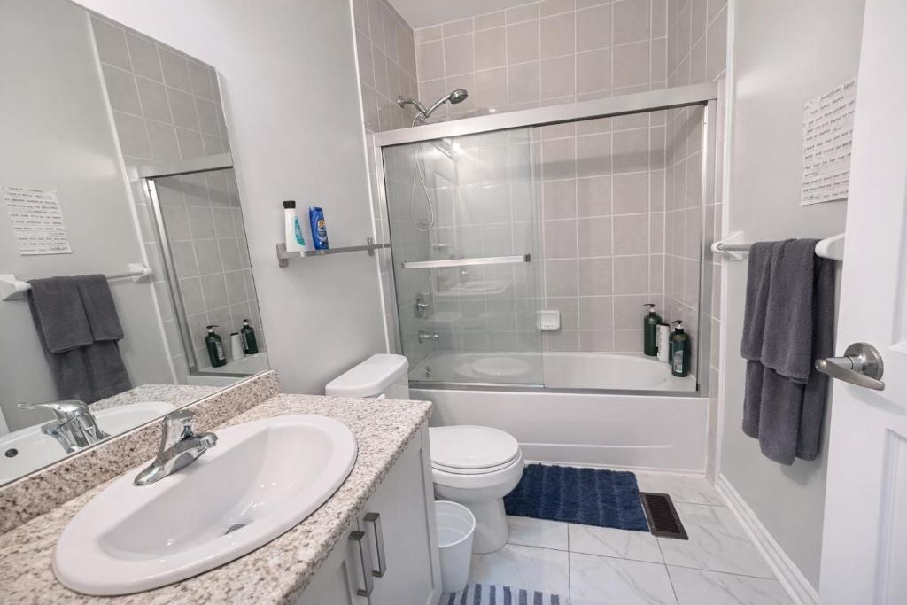a bathroom with a sink and a toilet and a shower at Quiet Private Master Suite w Ensuite Great Value in Bélanger