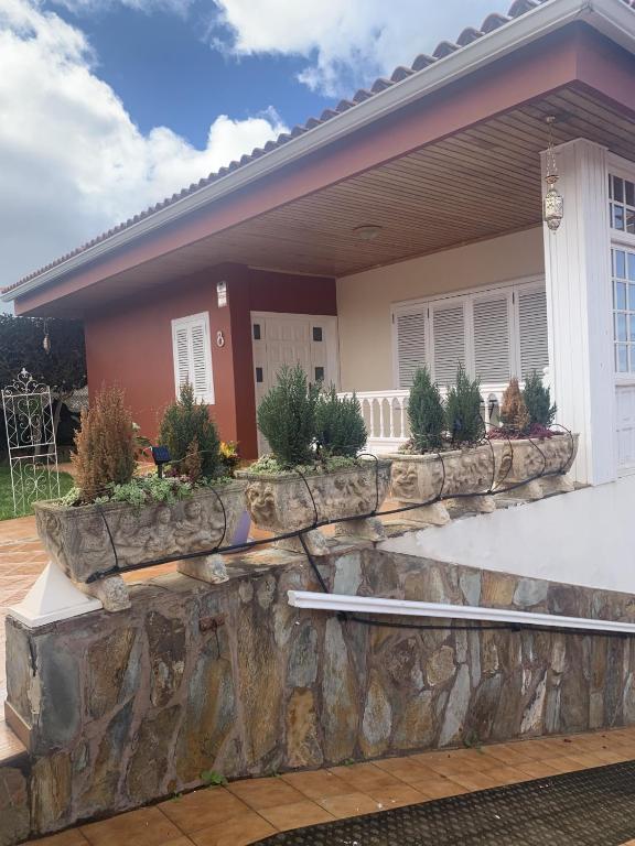 a house with a stone retaining wall in front of it at Chalet Tegueste Isla de Tenerife in Tegueste