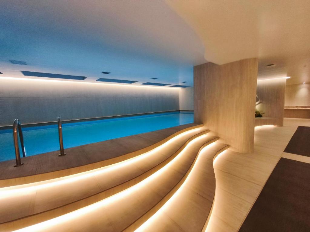 a swimming pool with lights in a building at Adagio Quito Coliving Ecuador Residences in Quito