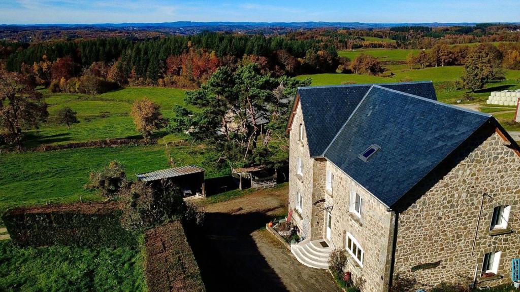 an aerial view of an old stone building with a black roof at Au doux refuge in Saint-Exupéry-les-Roches