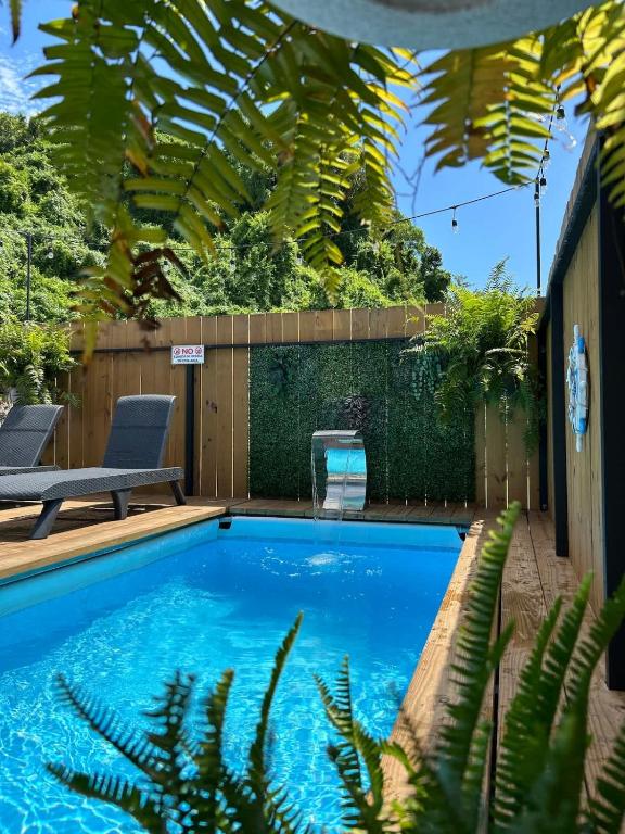 a swimming pool in a backyard with a bench and plants at Villa Morivivi Couples with pool in Tierras Nuevas Poniente