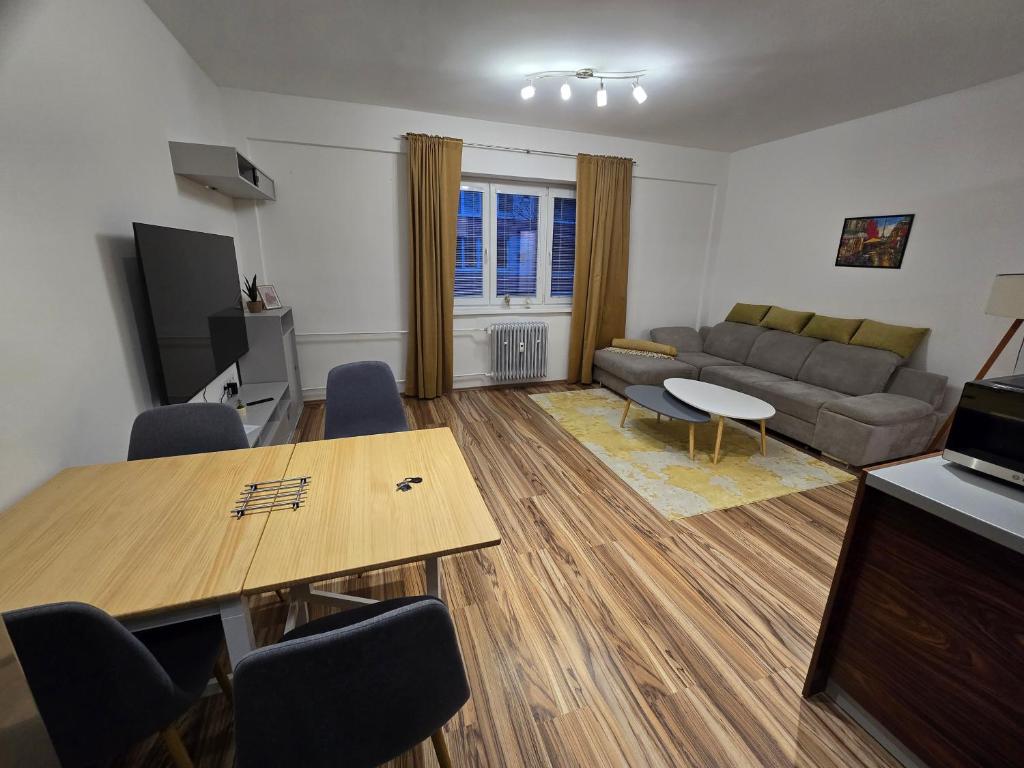 a living room with a couch and a table at Central City Stay Šancová in Staré Mesto