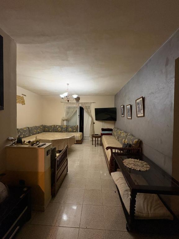a living room with couches and a couch and a table at Palm Beach in Mansouria