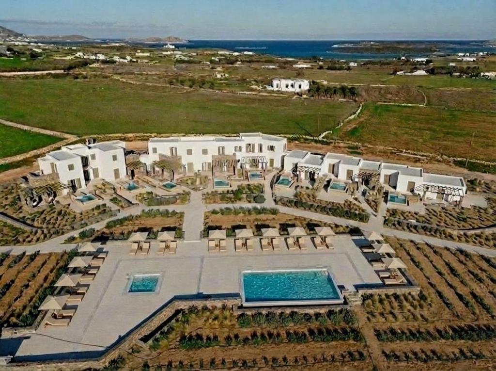 an aerial view of a resort with a swimming pool at White Cliff Villas Paros in Ambelas