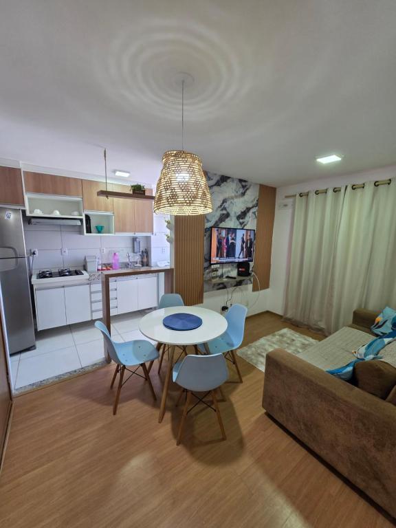 a kitchen and living room with a table and chairs at Torres dos Holandeses Vista Mar in São Luís