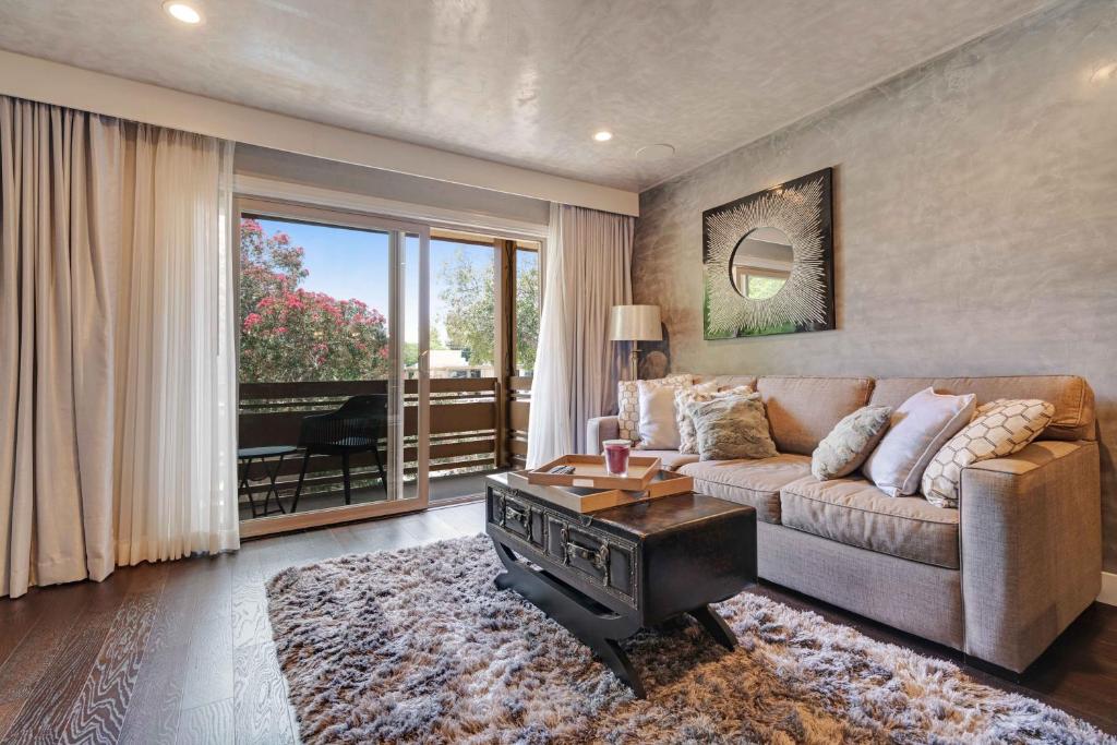 a living room with a couch and a large window at Luxury Condo Resort Amenities - Pool, Pickleball in San Diego