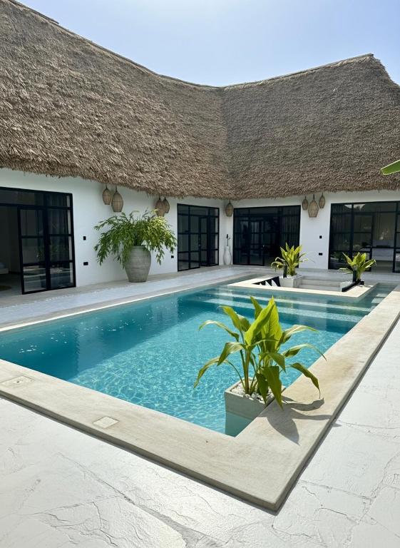 a swimming pool in front of a villa at Villa Jena 3 bedroom private pool in Nungwi