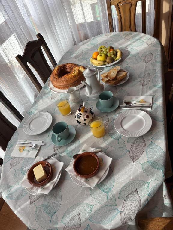 a table with a breakfast of bread and fruit on it at La Artesana in Posada de Rengos