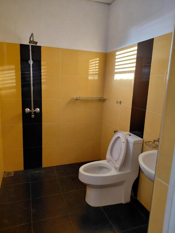 a bathroom with a toilet and a sink at Lovely beach hotel in Negombo