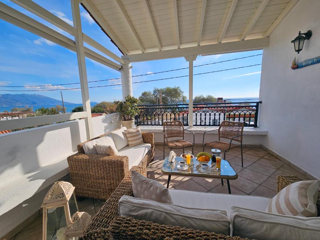 un patio con divani e un tavolo su un balcone di Captain's Loft Villa a Marathokampos