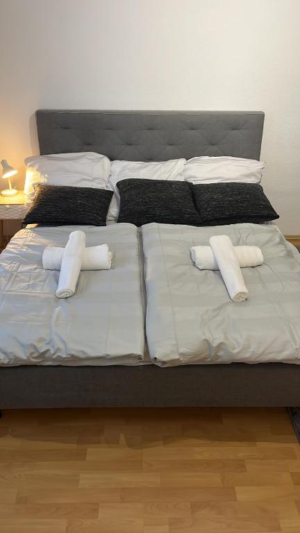 a large bed with white pillows on it at Kenny's place in Essen