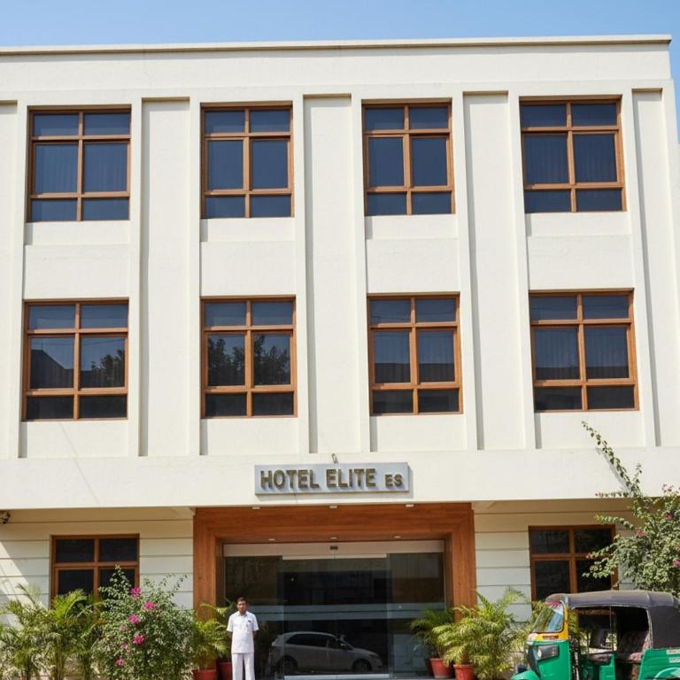 a man standing in front of a hotel building at Retrocka in Jāmb