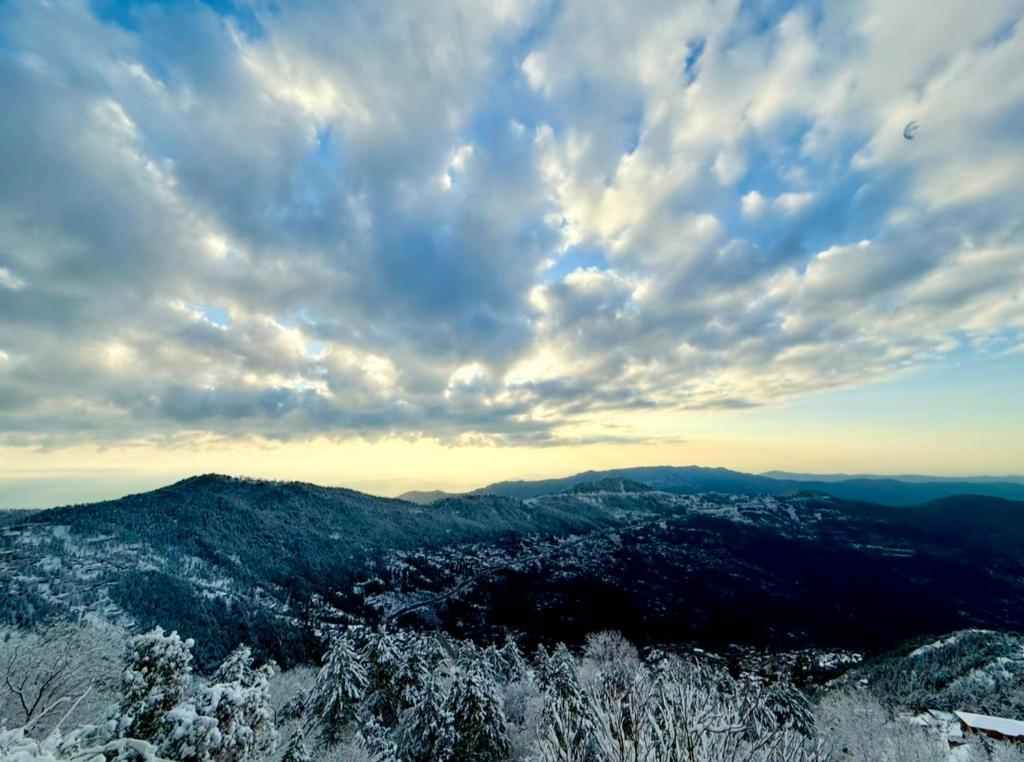 a view of the mountains under a cloudy sky at Arsalan holdings in Murree