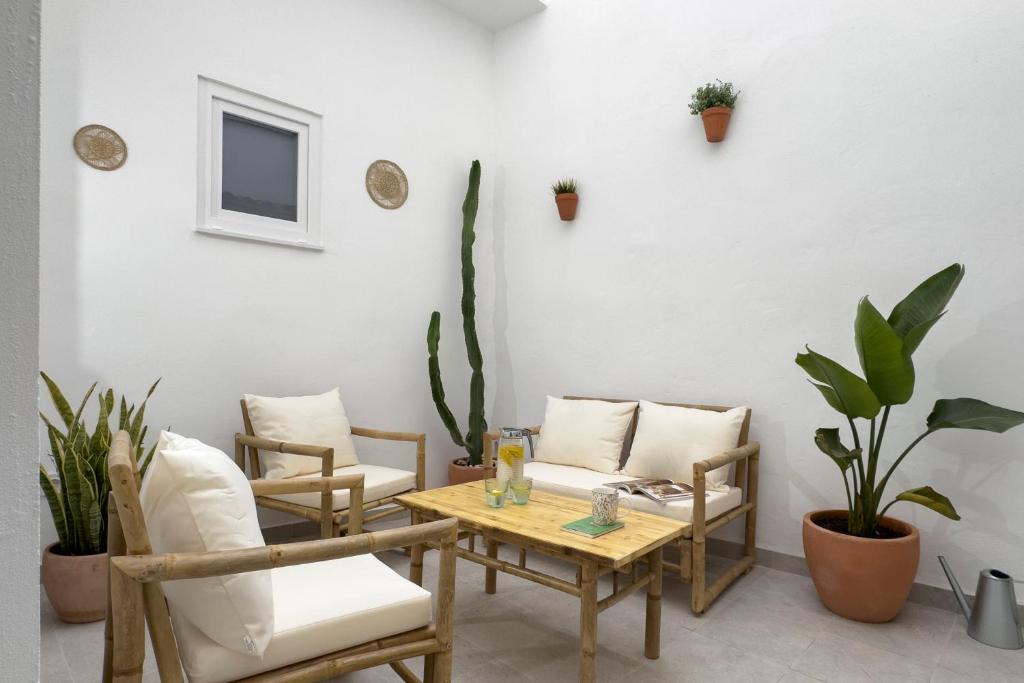a room with a table and chairs and plants at Casa La Pedrera in Pedralba