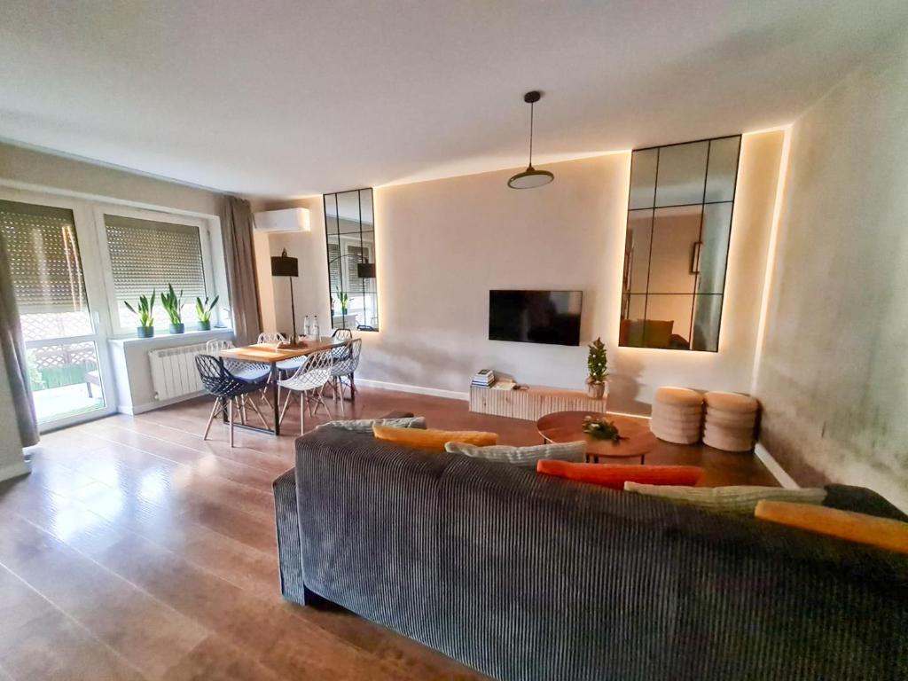 a living room with a couch and a table at Home4You free park in Krakow