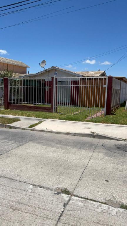 a fence on the side of a road next to a street at Casa familiar excelente ubicación in La Serena