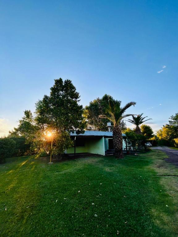a house in a yard with a green lawn at Cabañas Nono Mario in San Rafael