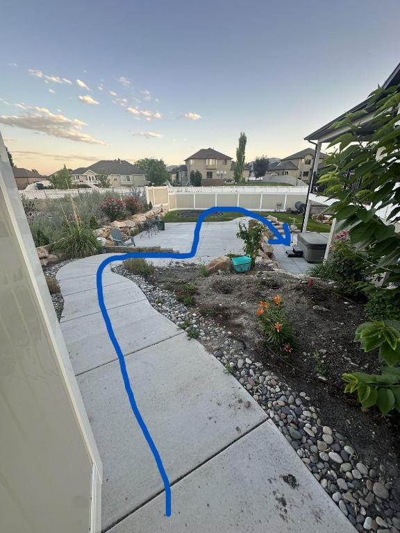 a blue hose on a sidewalk in a yard at Scenic Farmhouse in Riverton