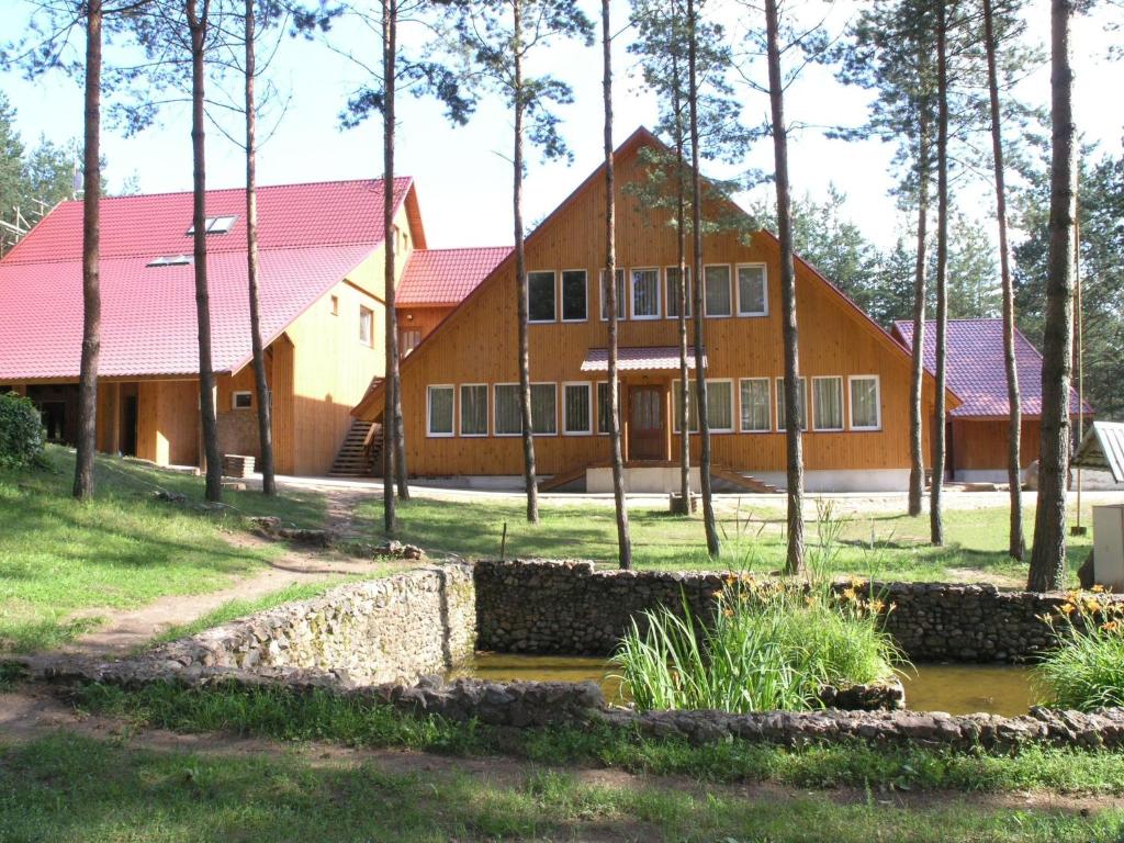 a large house with a red roof at Holiday Complex Šilaičiai in Seirijai