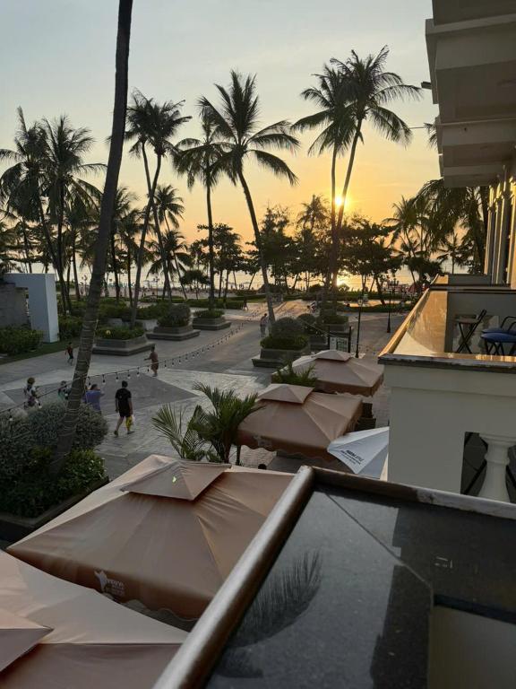 a view of a resort with palm trees and umbrellas at Marina Style Sea View Hotel in Phú Quốc