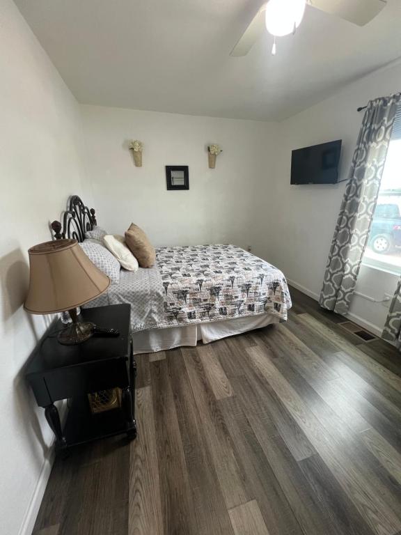 a bedroom with a bed and a table with a lamp at Near Red Mountain park in Mesa