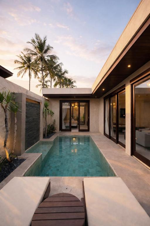 a swimming pool in the backyard of a house at Eden Villas Lombok in Kuta Lombok