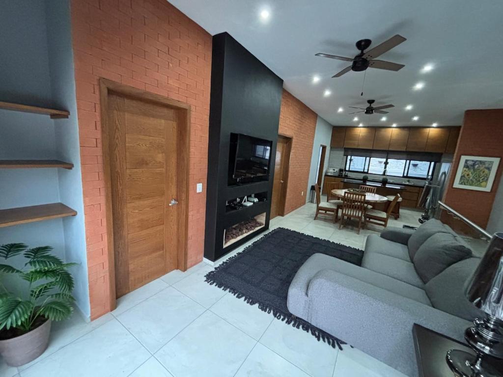 a living room with a couch and a ceiling fan at C apartment in Ajijic