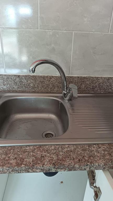 a sink with a faucet in a kitchen at Siyaya Palace in Jozini